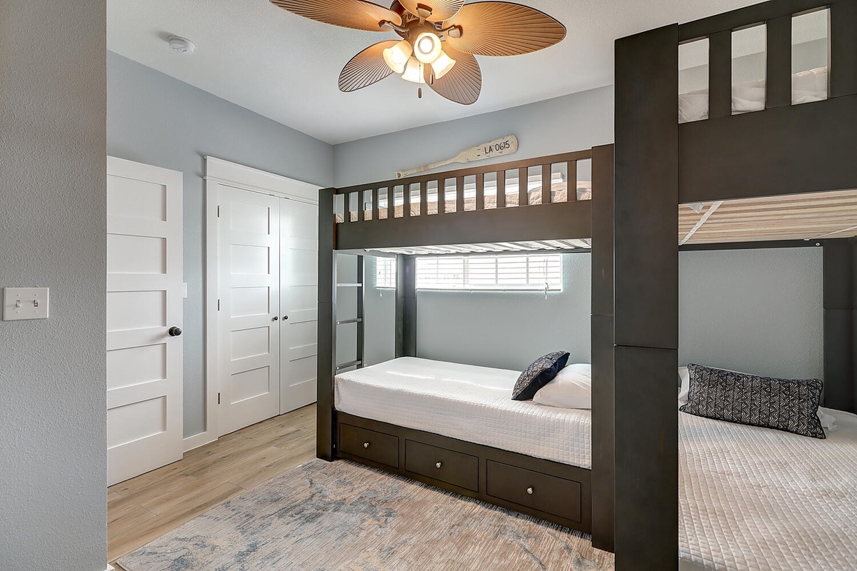 Your coastal bedroom features custom bunk beds with built-in storage, perfect for families or groups sharing adventures.