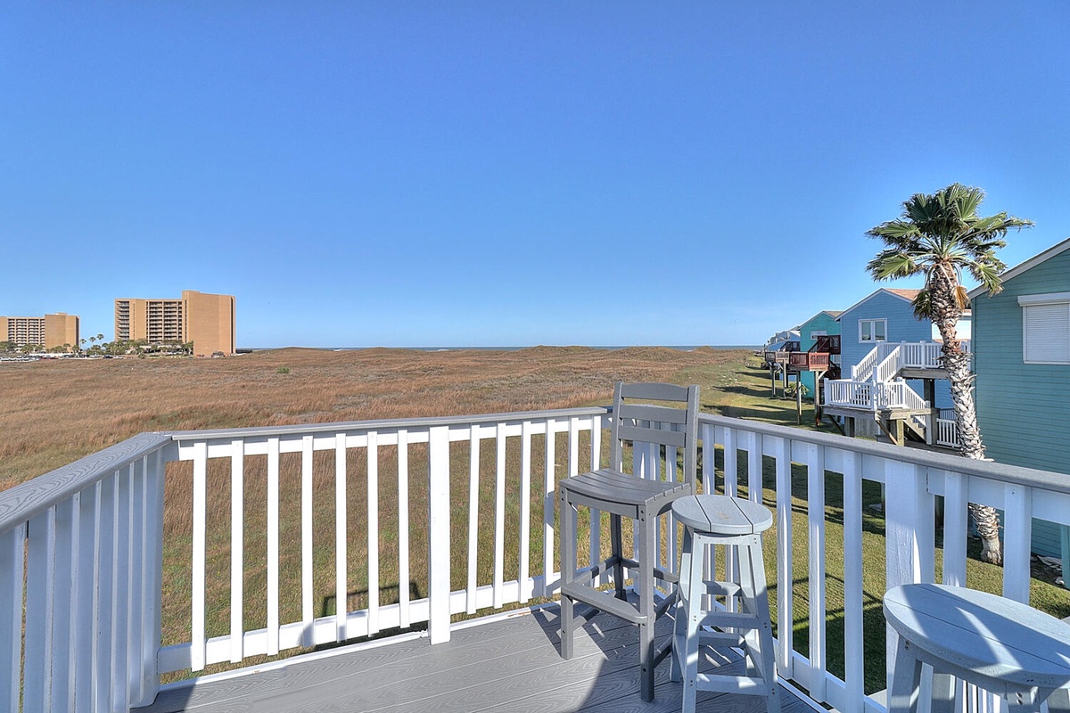 Sip your morning coffee on this peaceful balcony while taking in sweeping marsh views and distant coastal scenery.