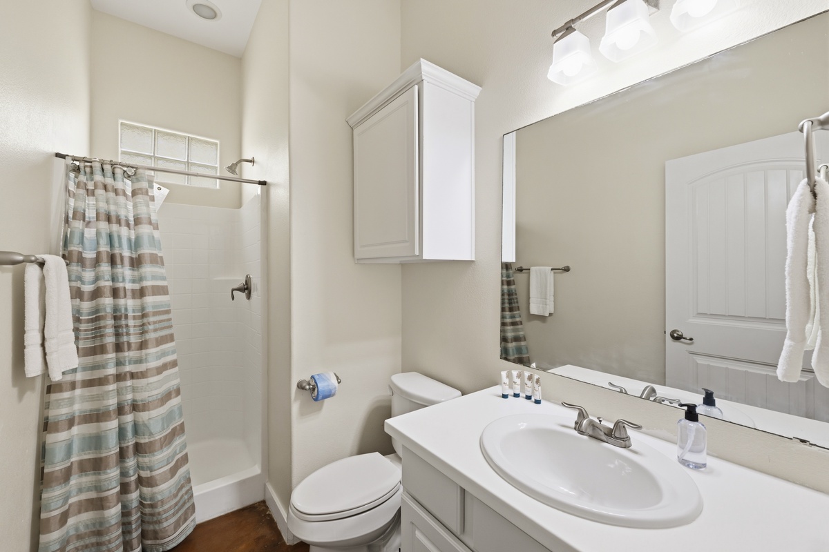 Your private bathroom features a fresh shower, modern fixtures, and soft towels—everything you need to feel refreshed and at home during your stay.
