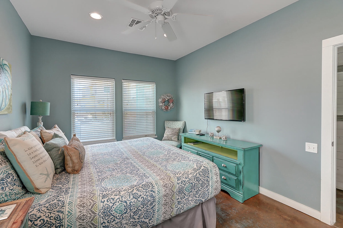 Drift off in this tranquil bedroom with soothing coastal colors, comfortable bedding, and your favorite shows on the flat-screen TV.