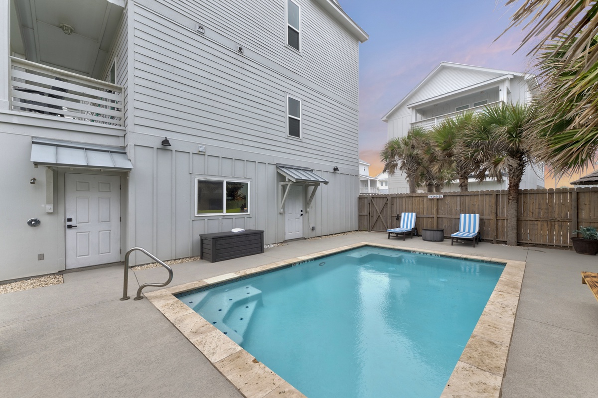 Your private pool oasis awaits, complete with hot tub and lounge chairs for sunset relaxation.