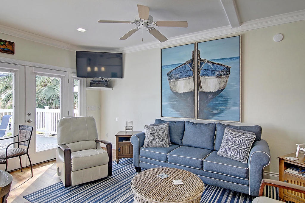 Unwind in this coastal-themed living room where nautical artwork and ocean blues create your perfect seaside retreat sanctuary.