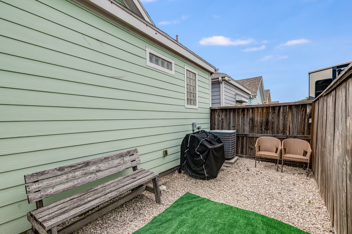 Relax in your private fenced patio with cozy seating and a convenient barbecue setup for memorable outdoor dining experiences.