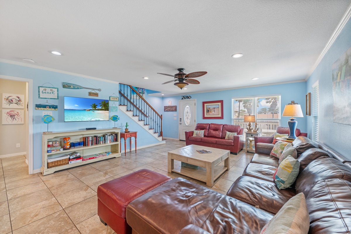 Settle into plush leather seating in this cheerful coastal living room, where beach-themed decor and ocean blues create your perfect retreat.