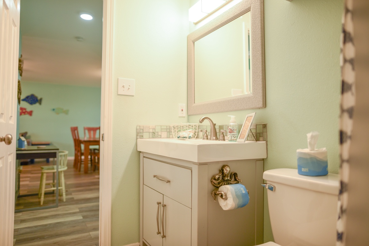 Your bright half-bath features coastal charm with playful touches and convenient access to the main living areas.