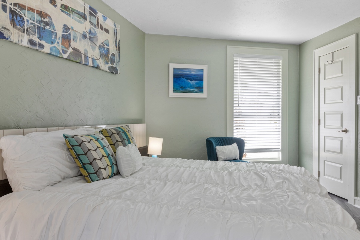 Sink into soft linens and ocean-inspired decor in your peaceful retreat, where calming blues and thoughtful touches create the perfect sanctuary.