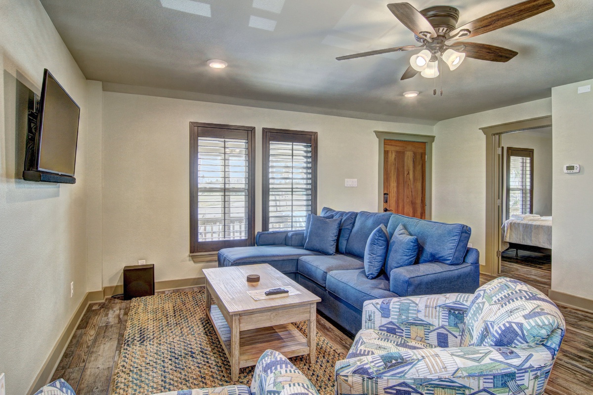 Sink into the plush blue sectional and feel instantly at home in your spacious living room, complete with ceiling fan comfort.