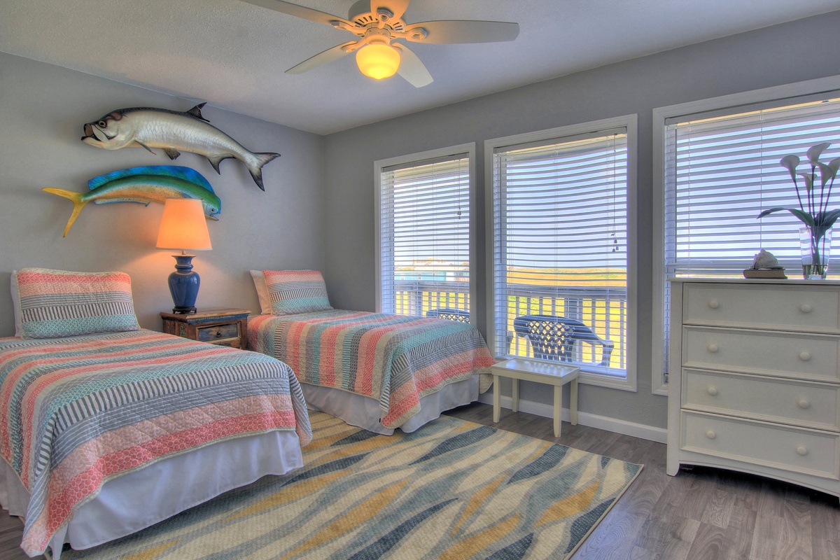 Drift off in this coastal-inspired twin bedroom, where cheerful sea-themed decor and gentle ocean breezes create your perfect seaside retreat.