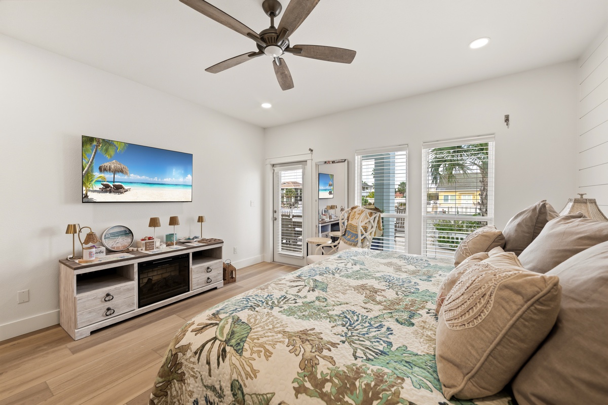 Step into your peaceful retreat with a plush bed, vaulted ceilings, and ceiling fan for comfort. French doors open to a sunny outdoor space where you can start your mornings with fresh air.