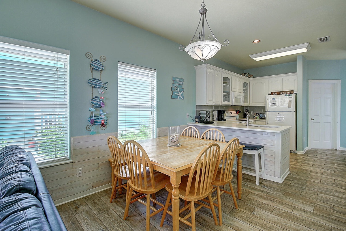 Your open kitchen and dining area flows seamlessly, bathed in natural light from large windows—perfect for morning coffee and family meals.