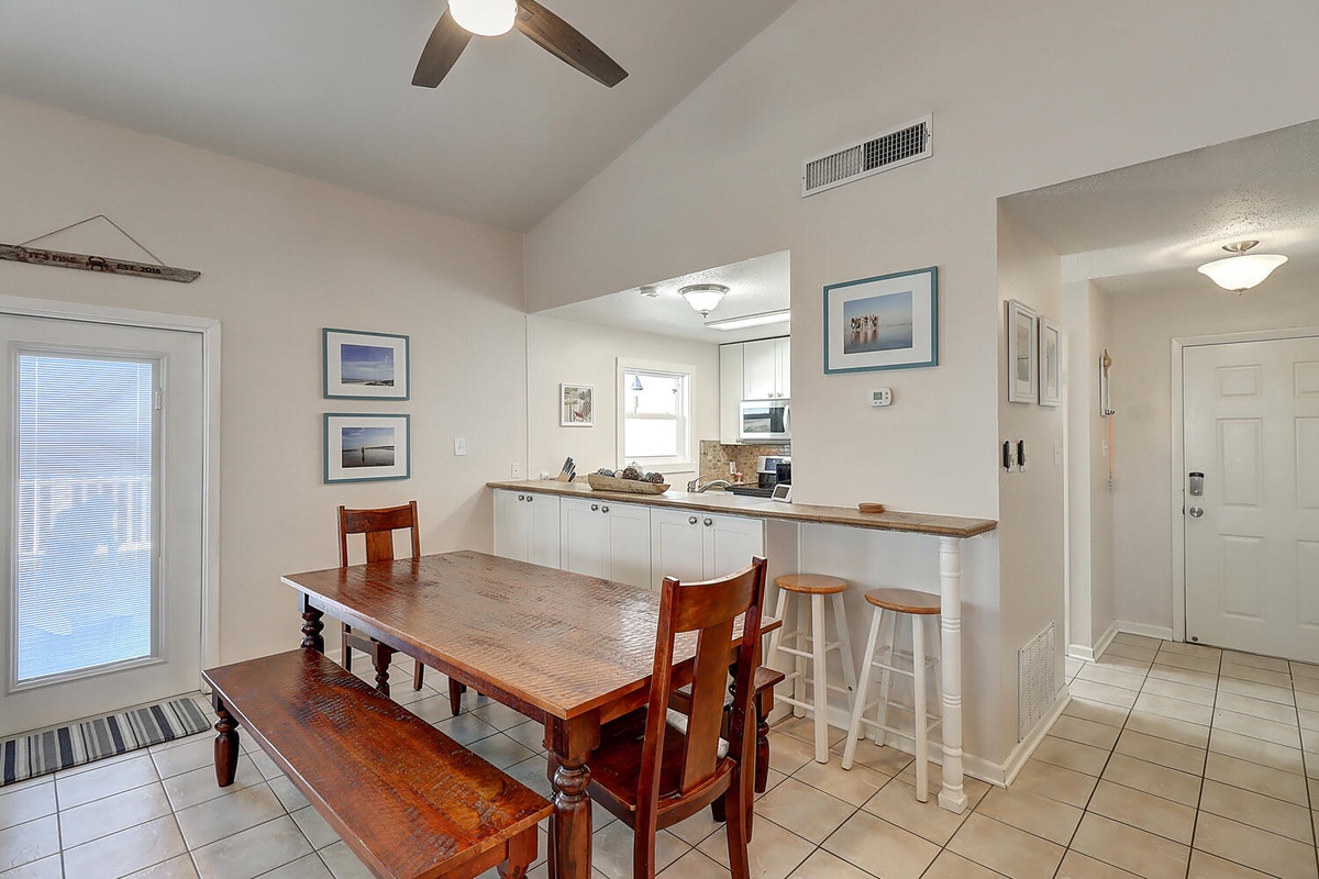 Your open kitchen and dining area invites morning coffee at the breakfast bar or family meals around the warm wooden table.