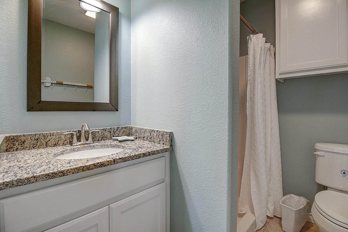 Step into your pristine bathroom with granite countertops, modern fixtures, and fresh towels awaiting your arrival.