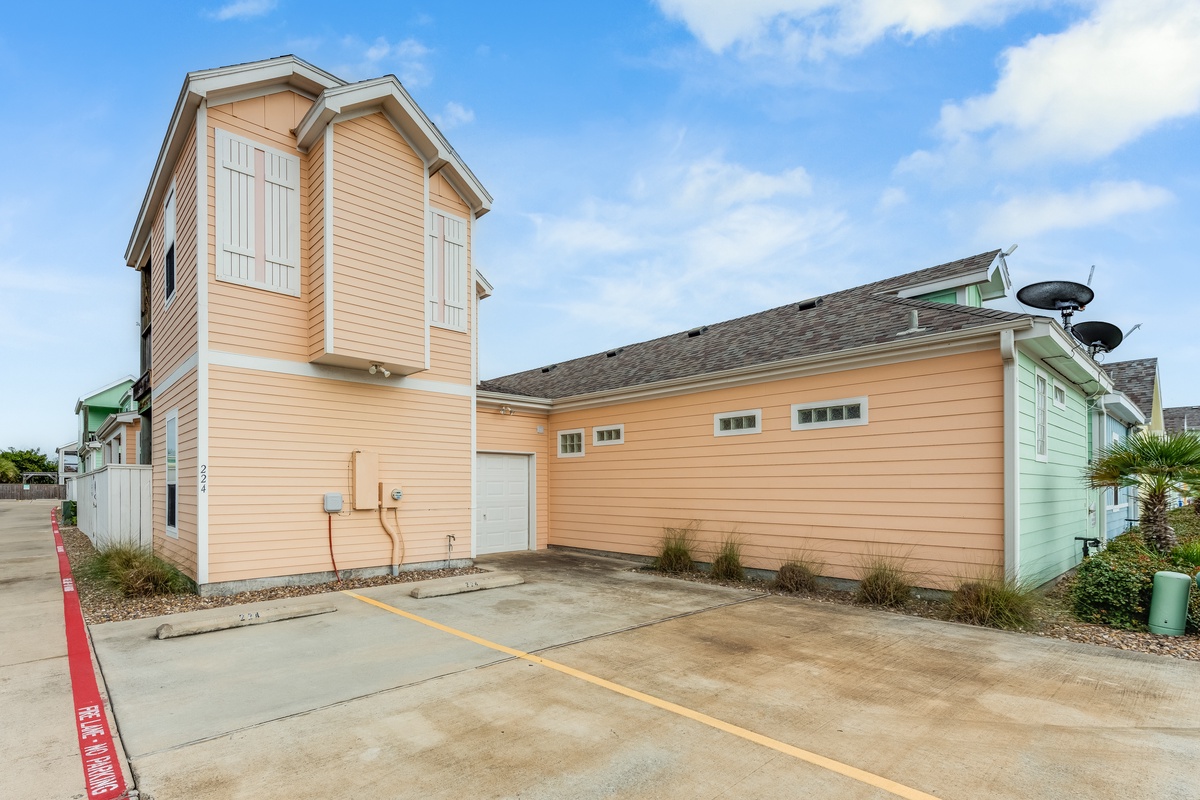 Charming beach cottage with distinctive architecture and dedicated parking space in a peaceful coastal community.