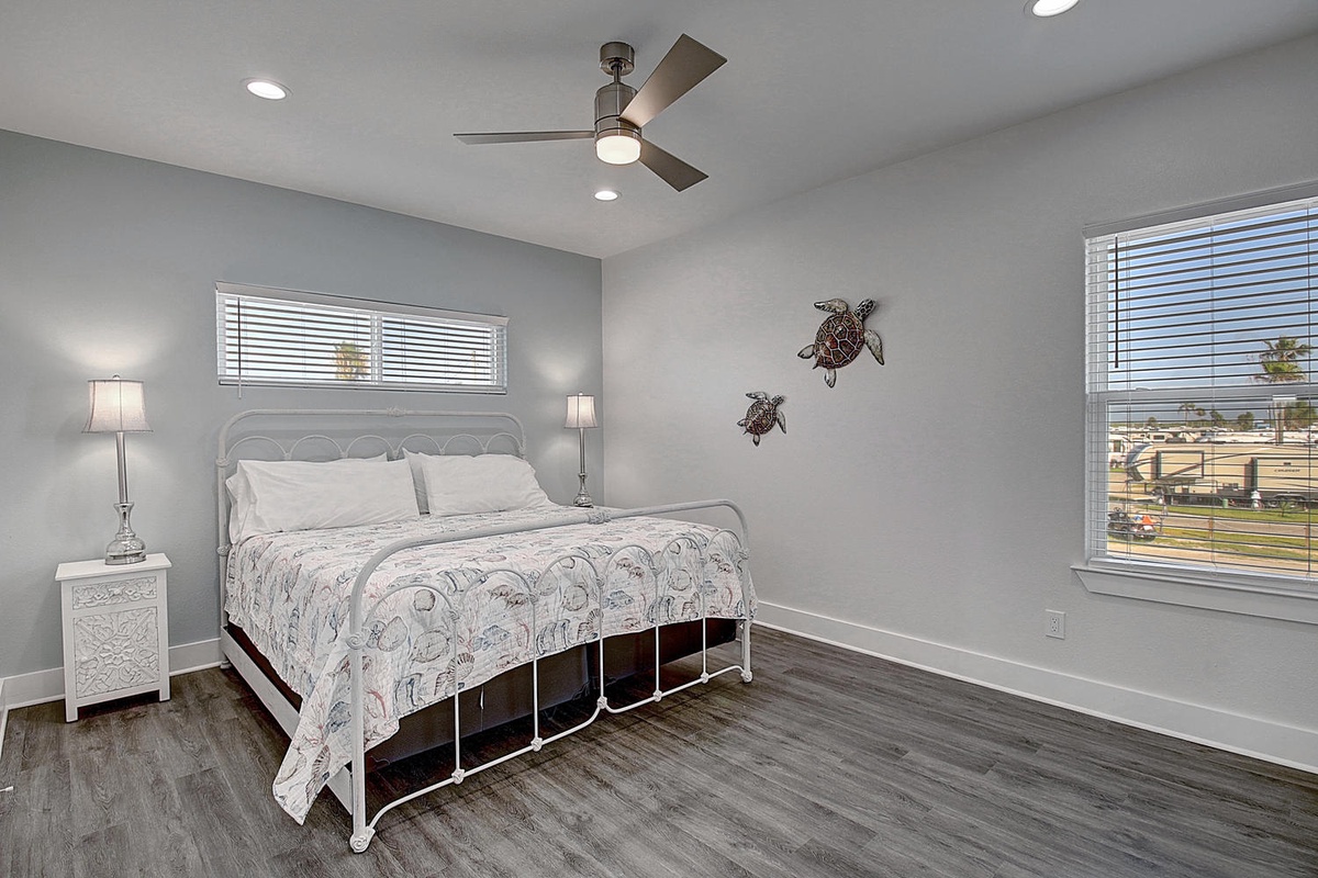 Drift off peacefully in your serene bedroom with coastal charm, featuring a comfy bed and gentle sea turtle art to inspire sweet dreams.