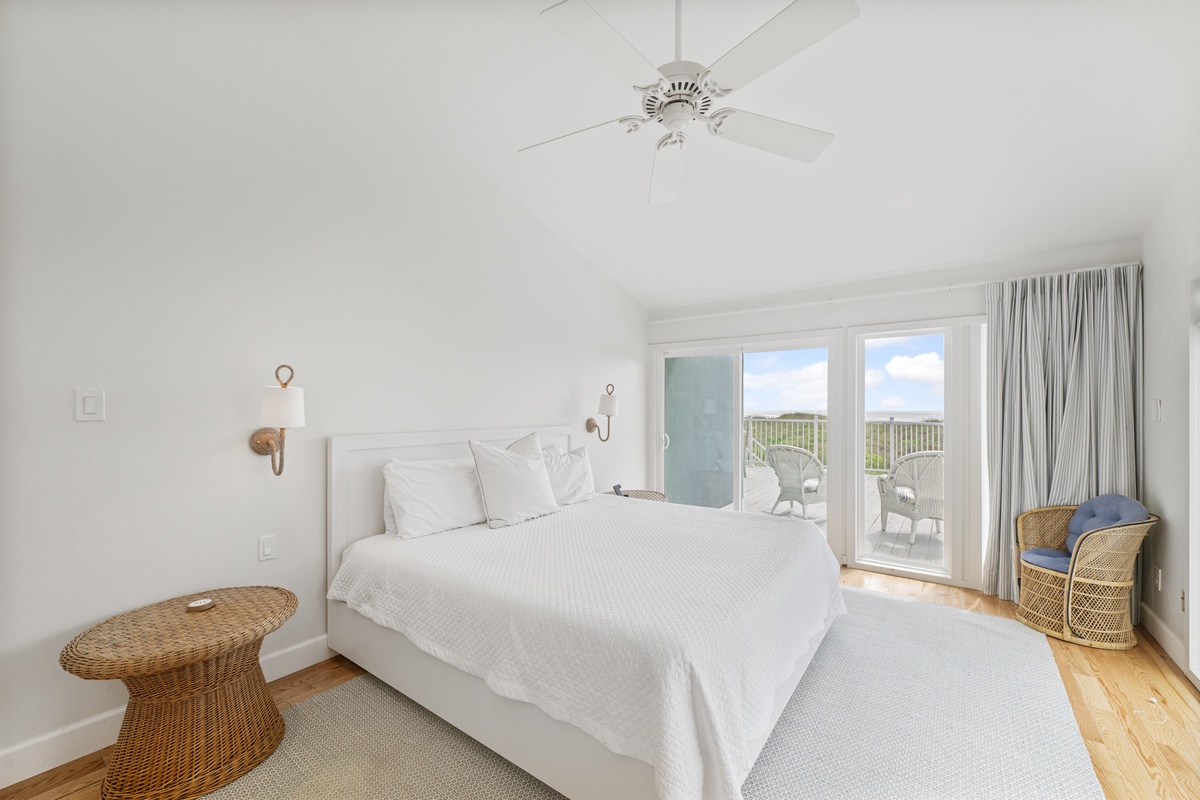 Drift off to sleep in this serene bedroom where crisp white linens and natural textures create your peaceful retreat.