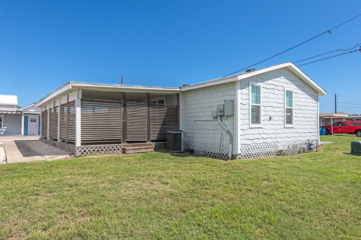 A charming beachside cottage with covered porch and private outdoor space, perfectly positioned in a quiet coastal community.