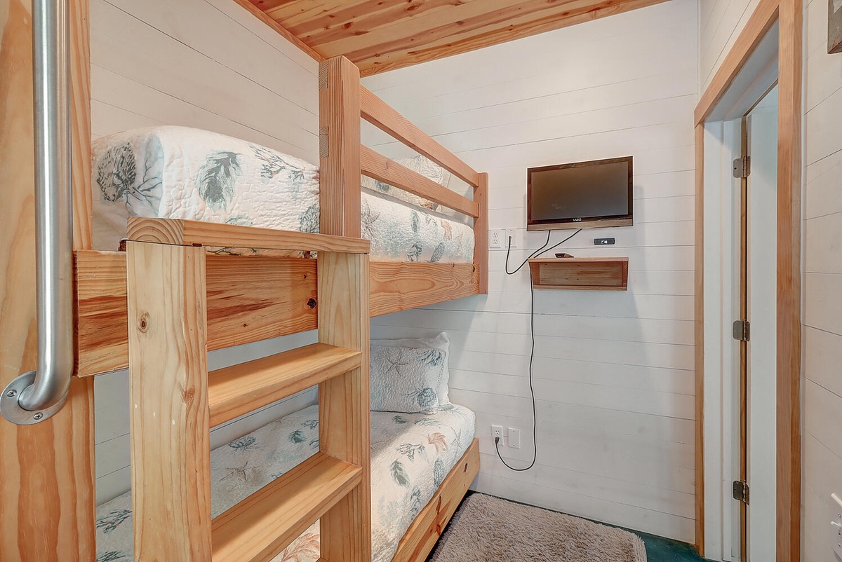 Cozy bunk beds with your own mounted TV create the perfect space for restful nights and leisurely mornings.