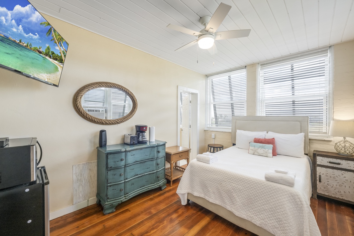 Rest easy in your stylish bedroom with crisp linens, comfortable seating, and warm hardwood floors. (Upgraded to a queen bed, new photos coming soon)