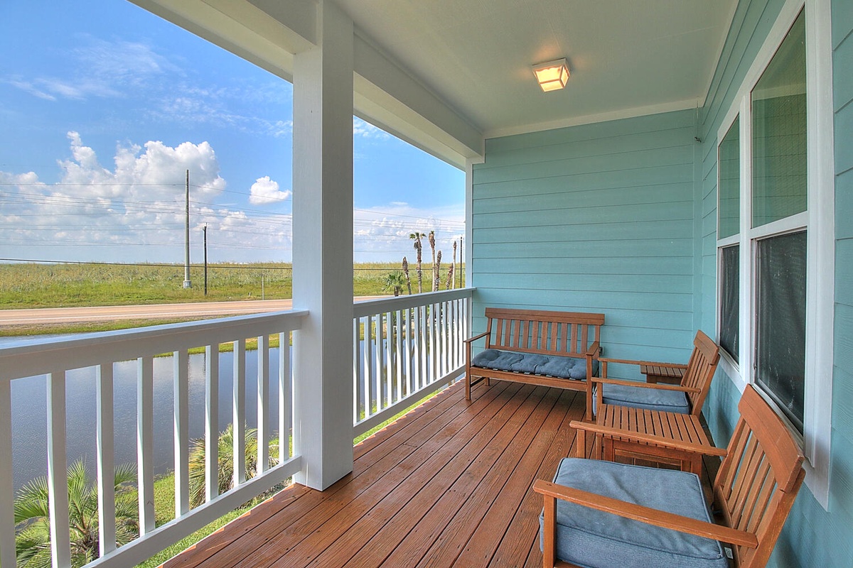 Relax on your private covered balcony with comfortable seating, overlooking peaceful countryside views - perfect for morning coffee or evening unwinding.