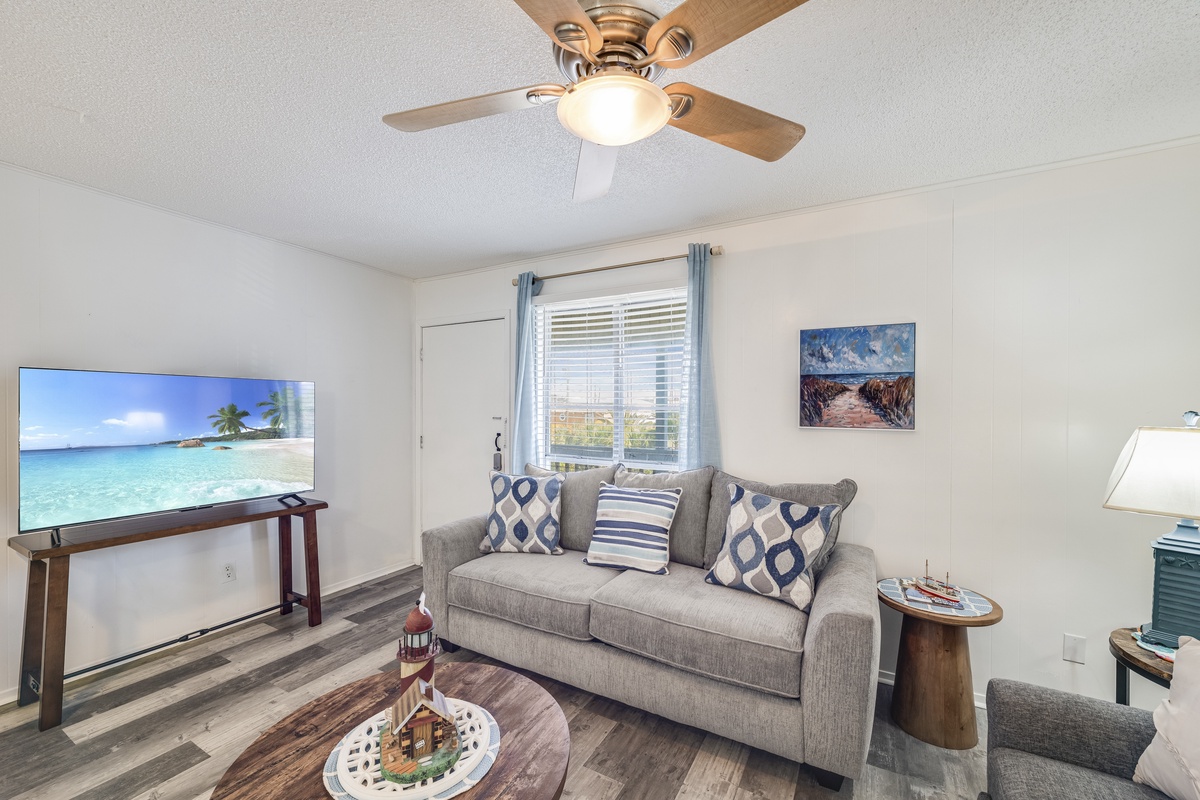 Unwind in your bright living space with plush seating and tropical views on the TV, perfect for relaxing after exploring.