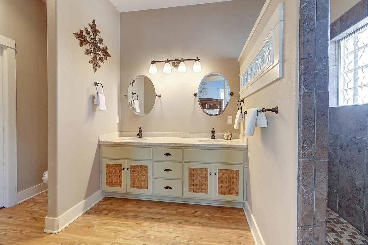 Step into your elegant ensuite with dual vanities, warm lighting, and a spacious walk-in shower.