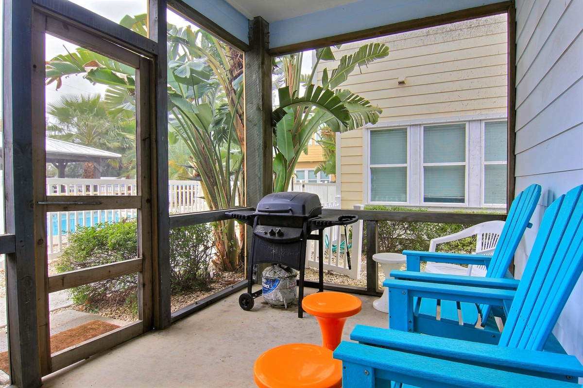 Fire up the grill on your private screened porch while sinking into vibrant blue Adirondack chairs surrounded by tropical palms.