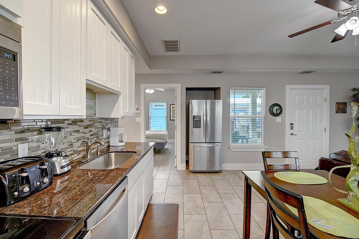 Your spacious kitchen invites culinary adventures with granite counters, modern appliances, and a breakfast nook where morning coffee tastes perfect.
