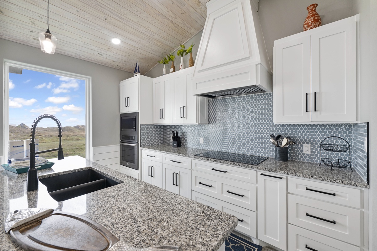Craft your favorite meals in this stunning kitchen with granite counters, premium appliances, and breathtaking natural views through your picture window.