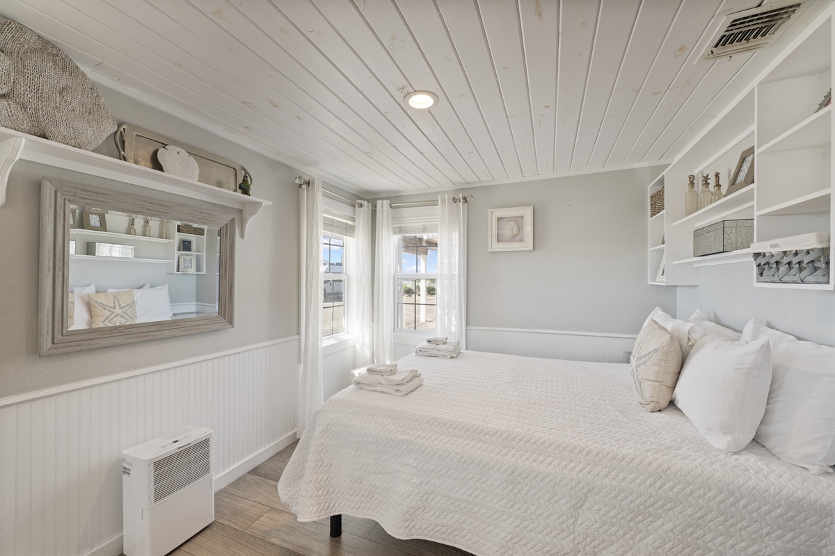 Rest peacefully in your bright, coastal-inspired bedroom with built-in storage and charming nautical touches throughout.