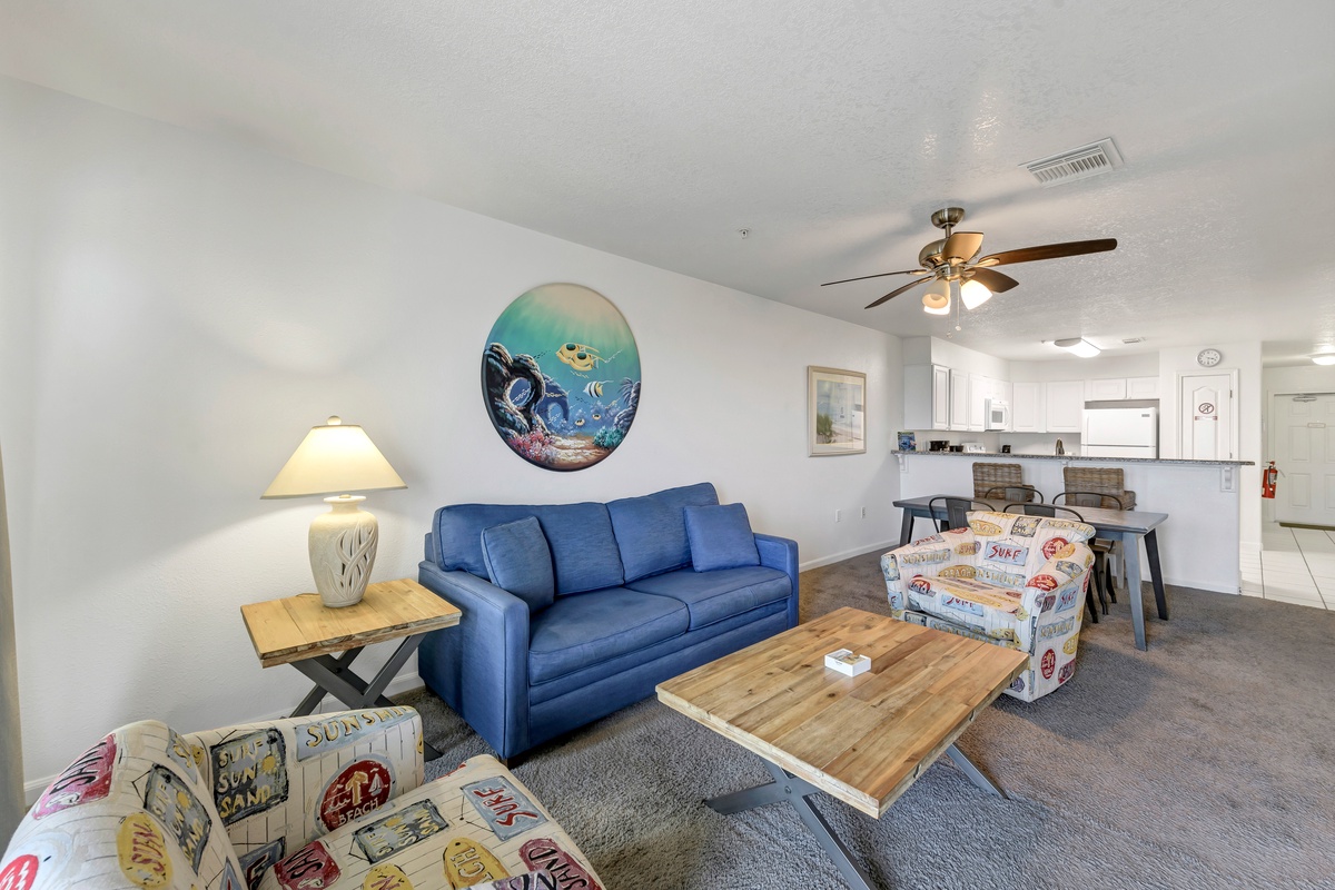 Settle into your inviting living space with comfortable seating, warm lighting, and an open-concept layout that flows seamlessly into your fully-equipped kitchen. The ceiling fan keeps you cool while you unwind after a day of adventure.