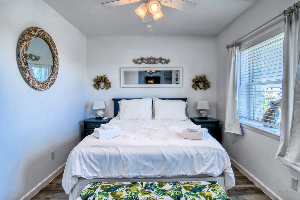 Drift off to sleep in your cozy bedroom, where crisp white linens await and gentle breezes flow through the window.