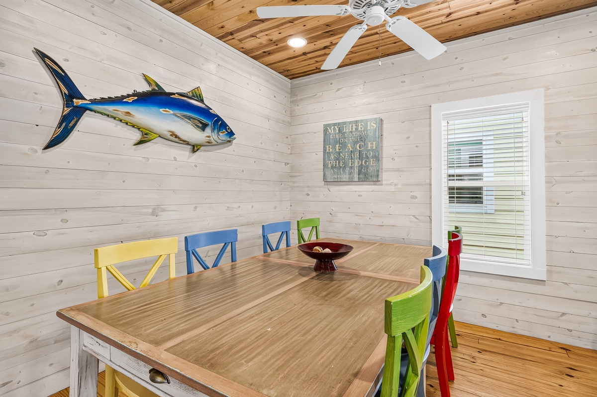 Gather around the spacious dining table where cheerful pops of color meet coastal charm—the perfect spot for your morning coffee or evening meals together.