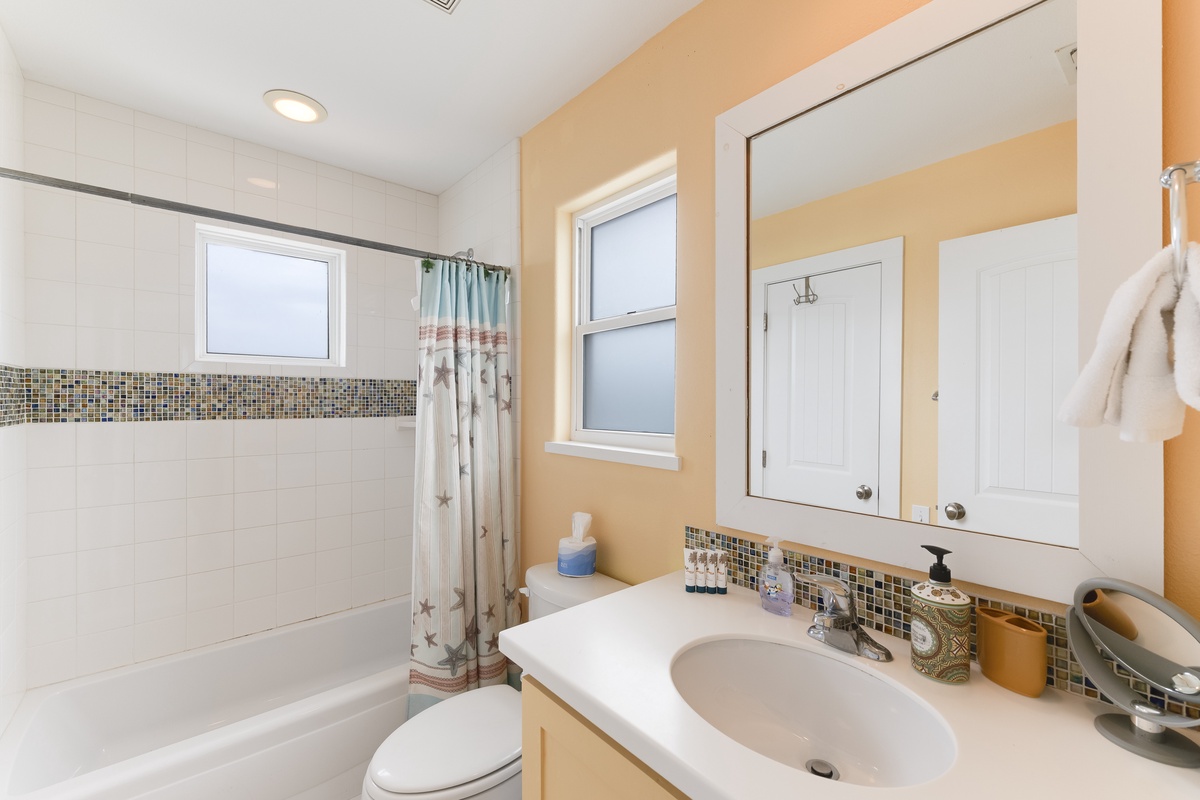 Unwind in your private bathroom featuring elegant mosaic tile accents and a relaxing tub-shower combo for refreshing mornings.