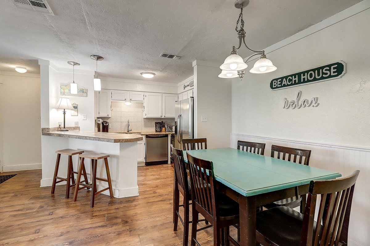 Relax in your spacious open-concept kitchen and dining area, where coastal charm meets modern comfort for memorable vacation meals.