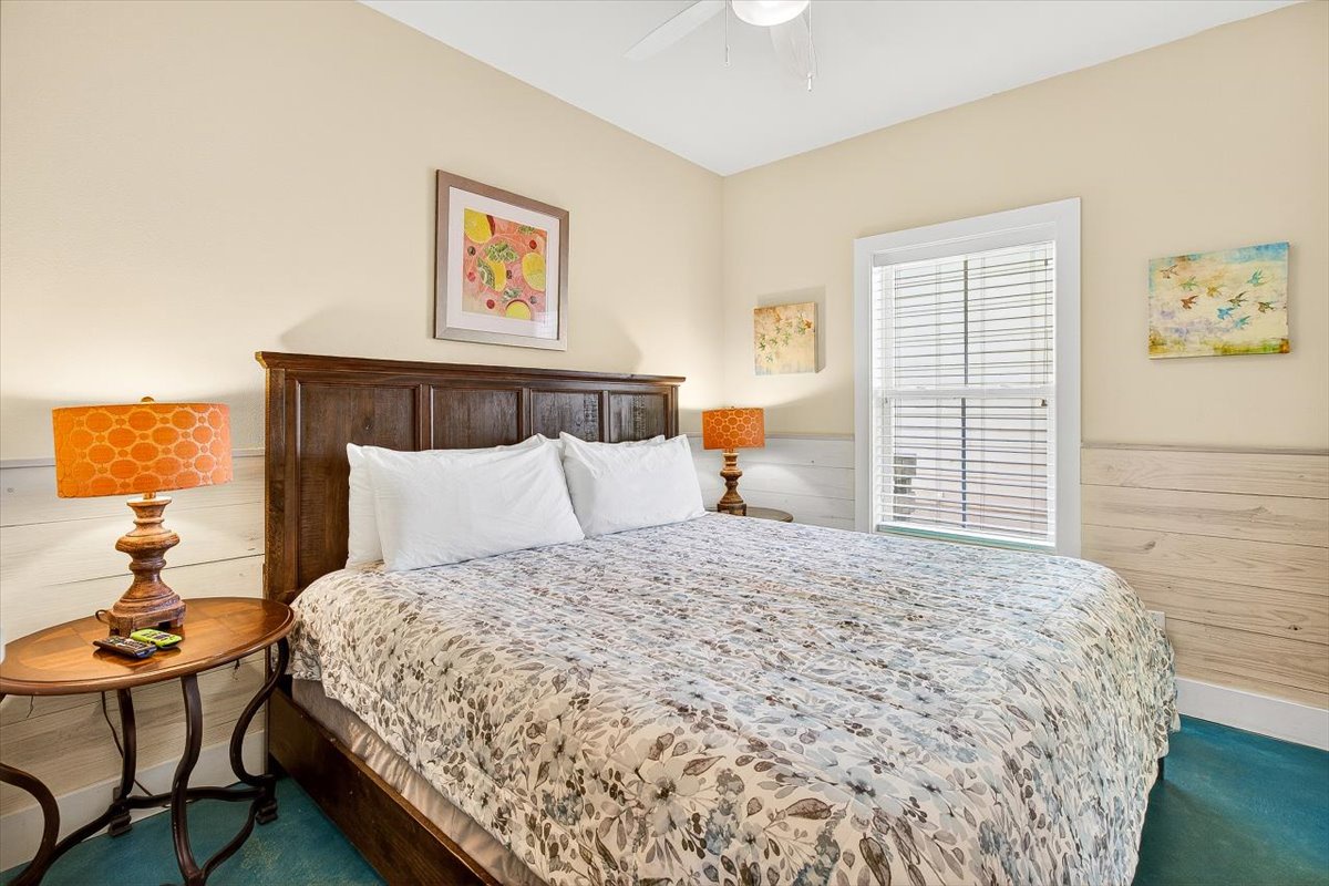 Sink into crisp white linens and fall asleep to the gentle breeze through your window in this charming bedroom retreat.