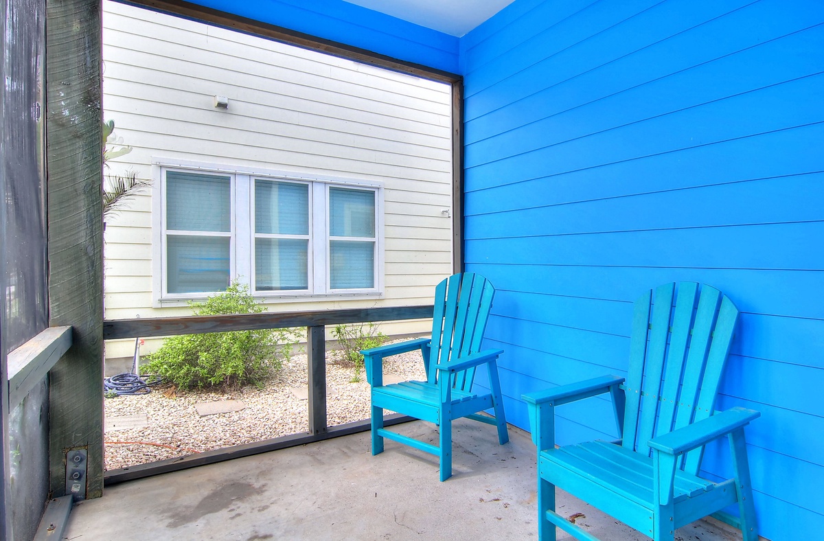 Your private balcony with turquoise Adirondack chairs offers the perfect spot to unwind and soak in coastal vibes.