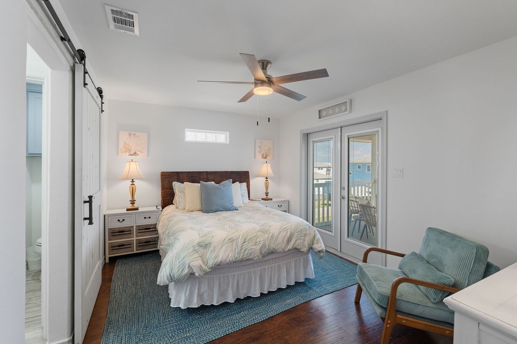Drift off peacefully in your coastal-inspired bedroom with soft linens, gentle fan breeze, and French doors opening to your private balcony retreat.