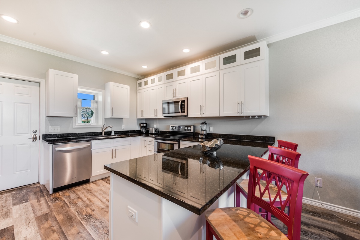 Your fully equipped kitchen features gleaming granite counters, stainless appliances, and a breakfast island where you'll start each morning perfectly.