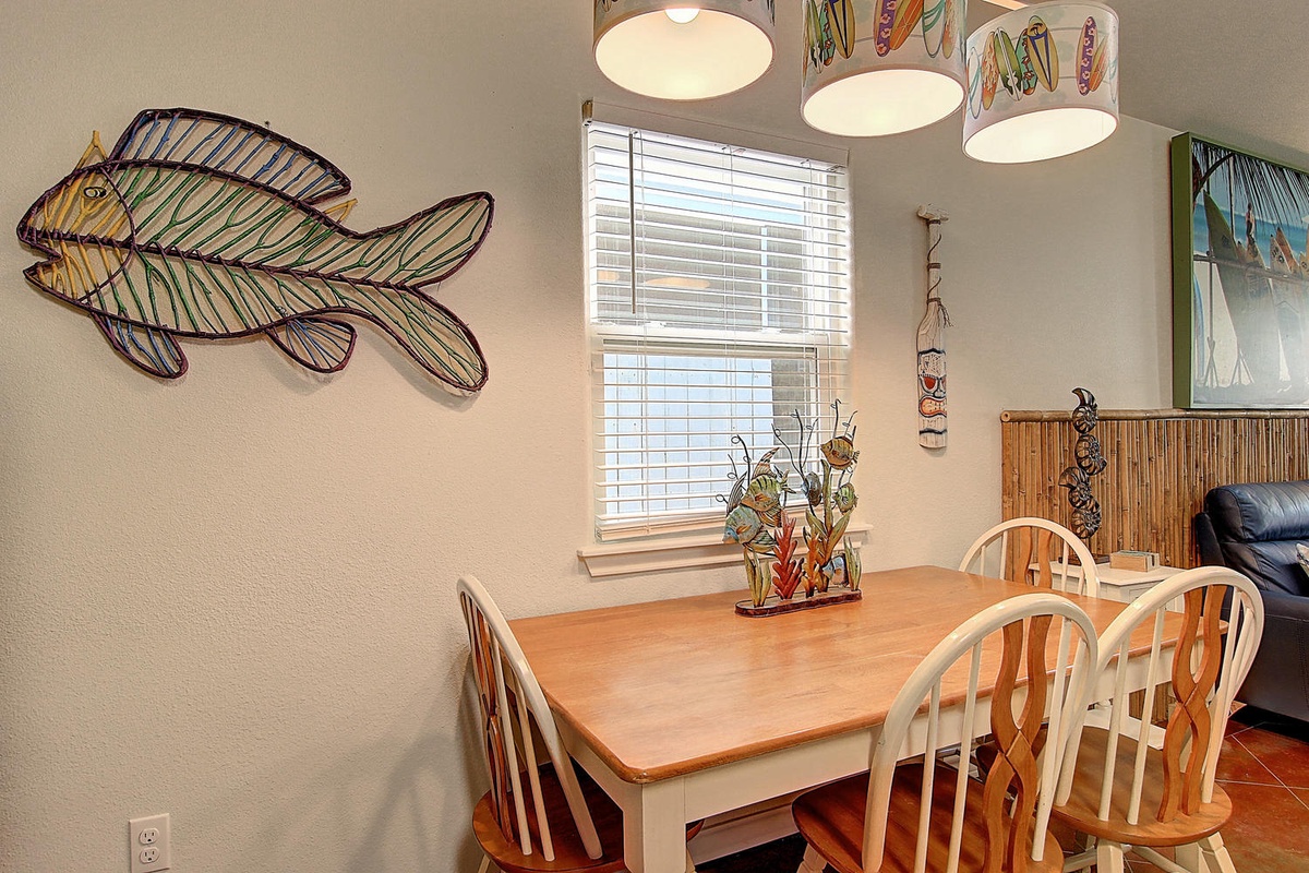 Gather around your charming dining table, where coastal-inspired decor and warm wood tones create the perfect backdrop for memorable meals.