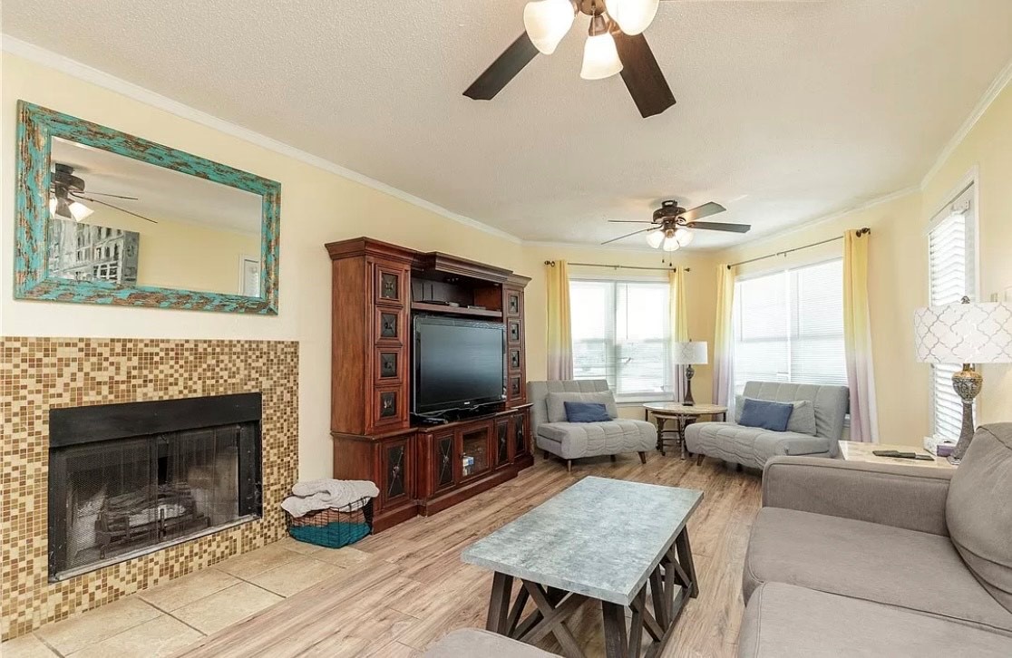 Relax in this spacious living room where you'll enjoy cozy seating, a tile fireplace, and entertainment center for memorable evenings together.