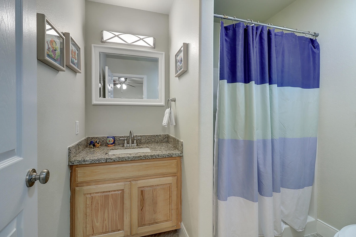 Your private bathroom features granite countertops and warm wood vanity, creating a welcoming space to refresh.