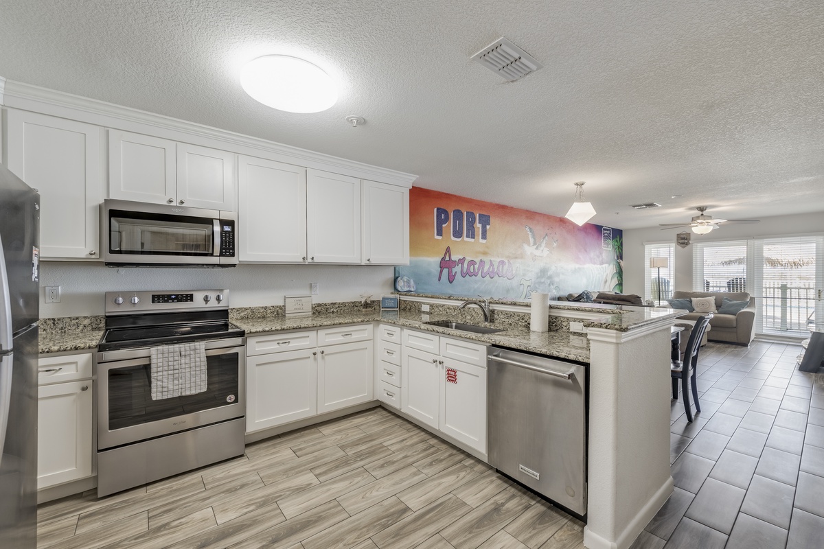 Your fully equipped kitchen features granite countertops, modern stainless steel appliances, and opens to a bright living space—perfect for gathering with loved ones.