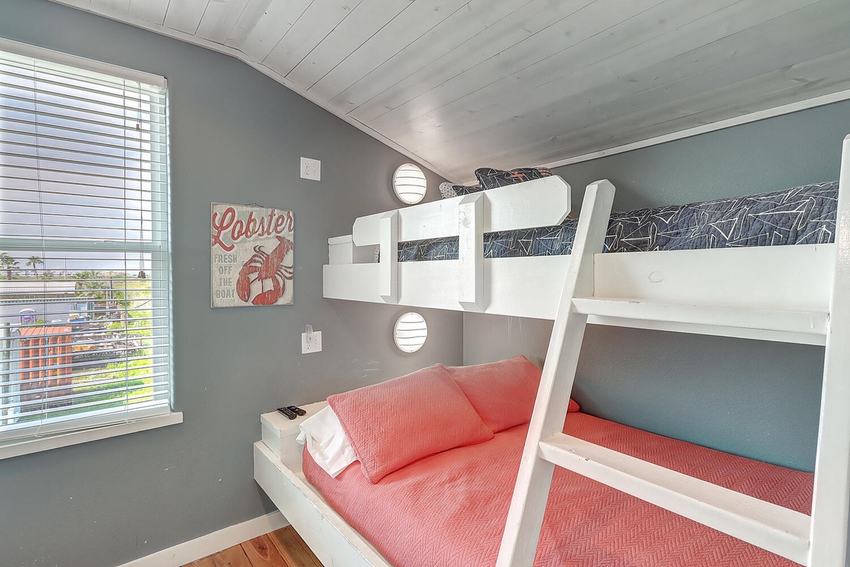 Your kids will love this fun bunk bed room with bright coral bedding and playful lobster artwork.