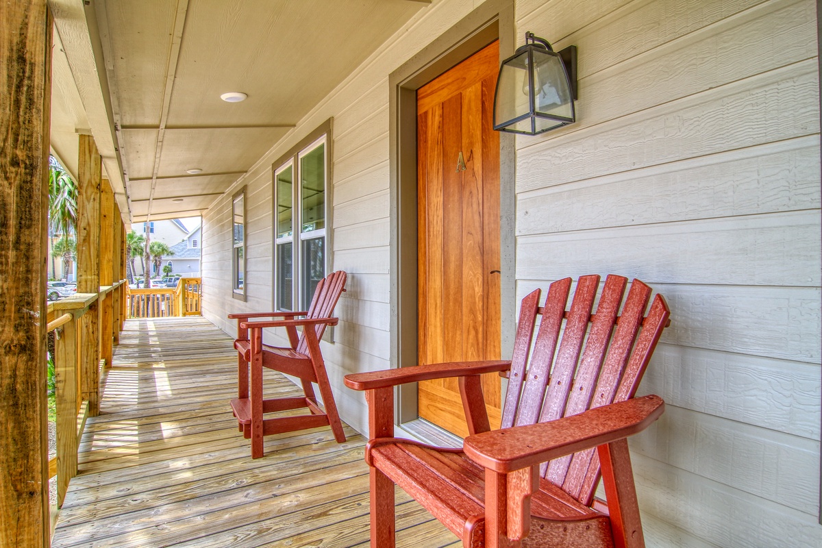 Unwind on your private covered porch with classic Adirondack chairs, perfect for morning coffee or evening relaxation.