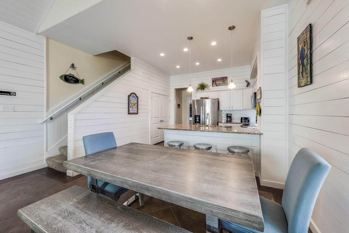 Gather around your stylish dining table in this bright, open space that flows into a fully equipped kitchen—perfect for memorable meals together.