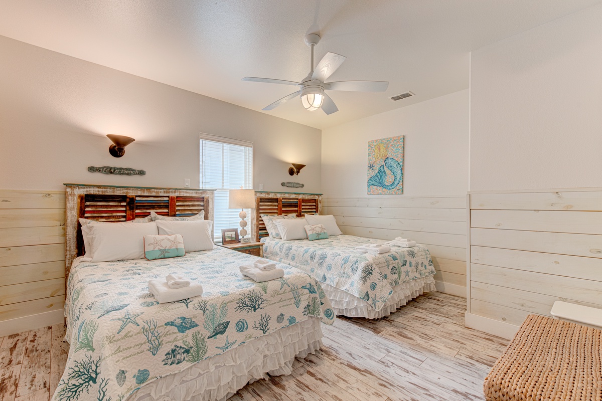 Rest peacefully in this coastal-themed bedroom with twin beds, ocean-inspired linens, and nautical touches that bring seaside serenity indoors.