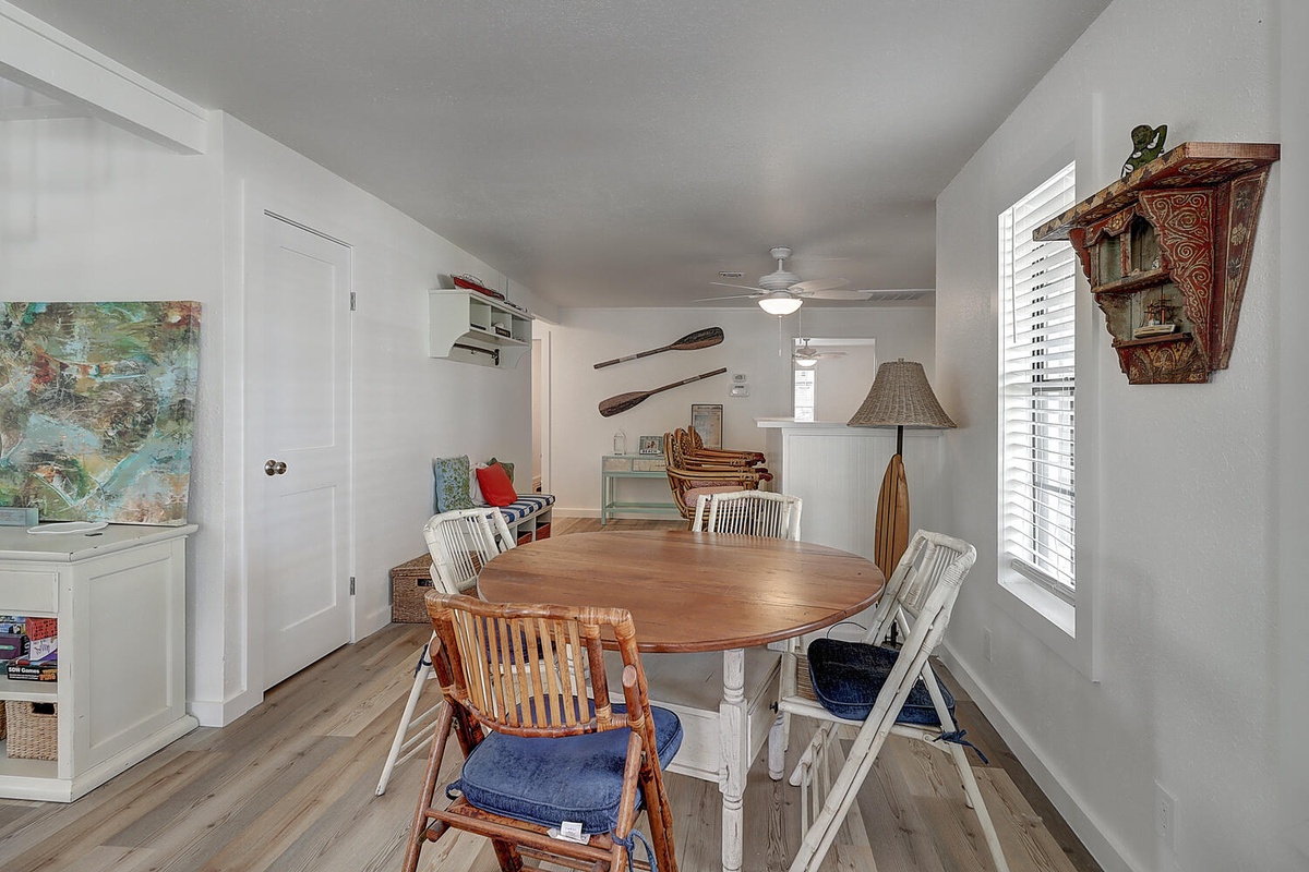 Your dining space features nautical charm with wooden oars and maritime art, perfect for memorable meals together.