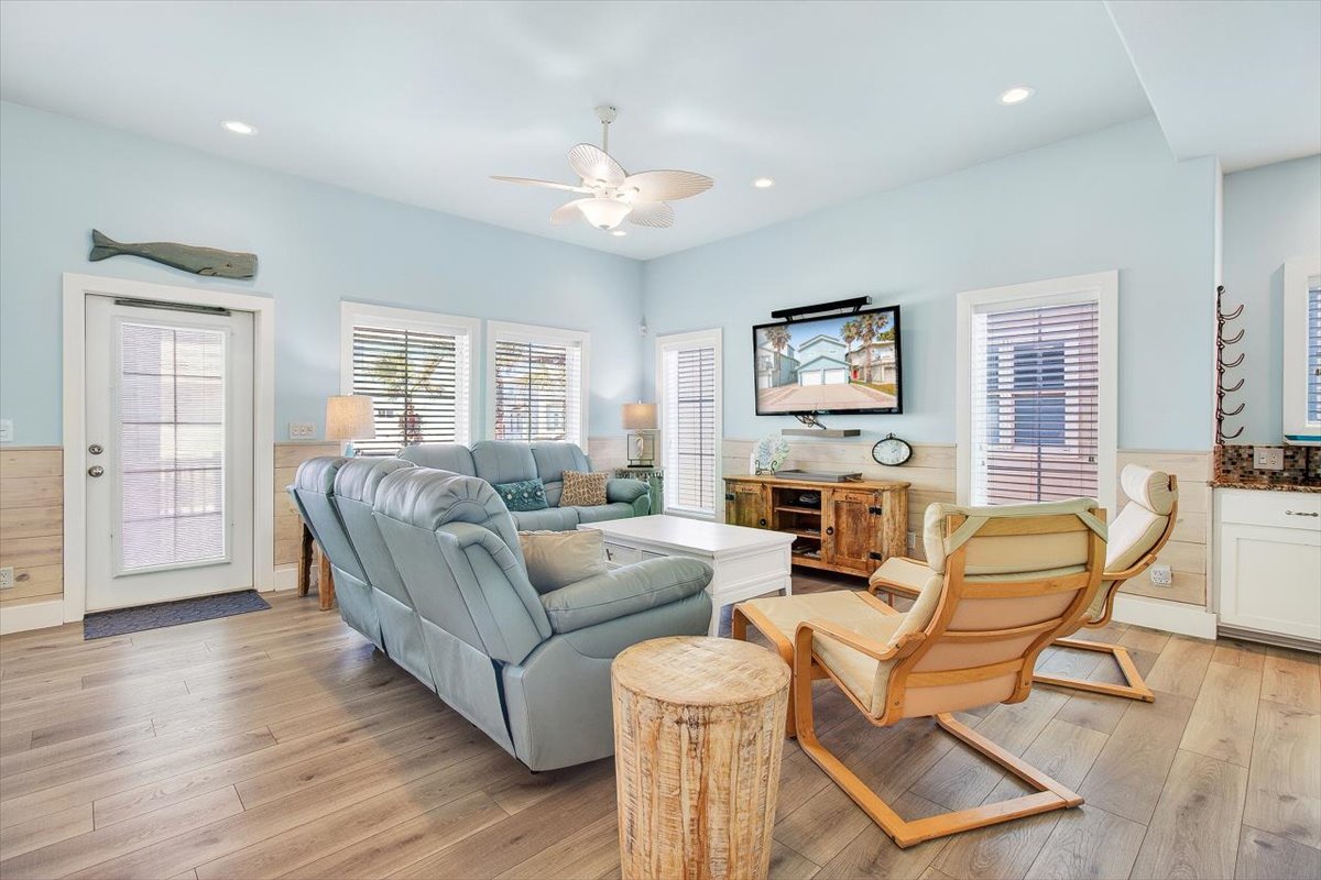 Relax in your coastal-inspired living room with plush seating, ocean views on the big screen, and sea-breeze blue walls that create the perfect beachy vibe.