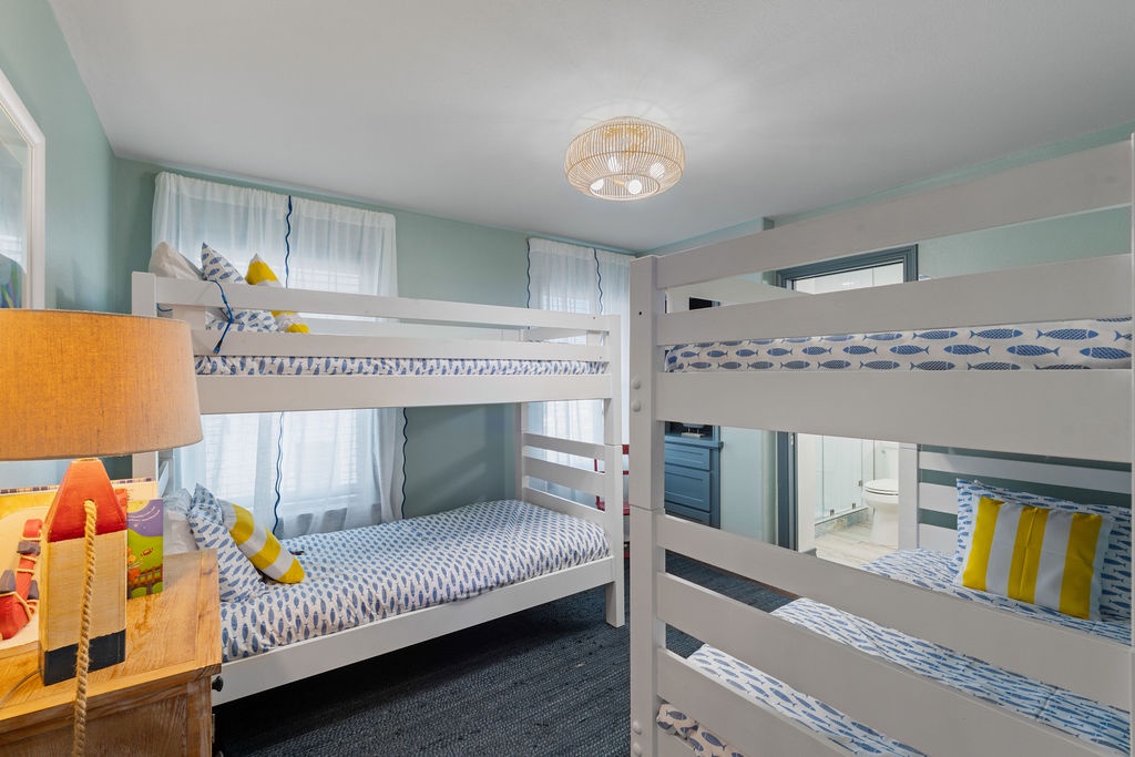Your kids will love this cheerful bunk room with cozy beds, playful nautical touches, and plenty of space for bedtime stories.