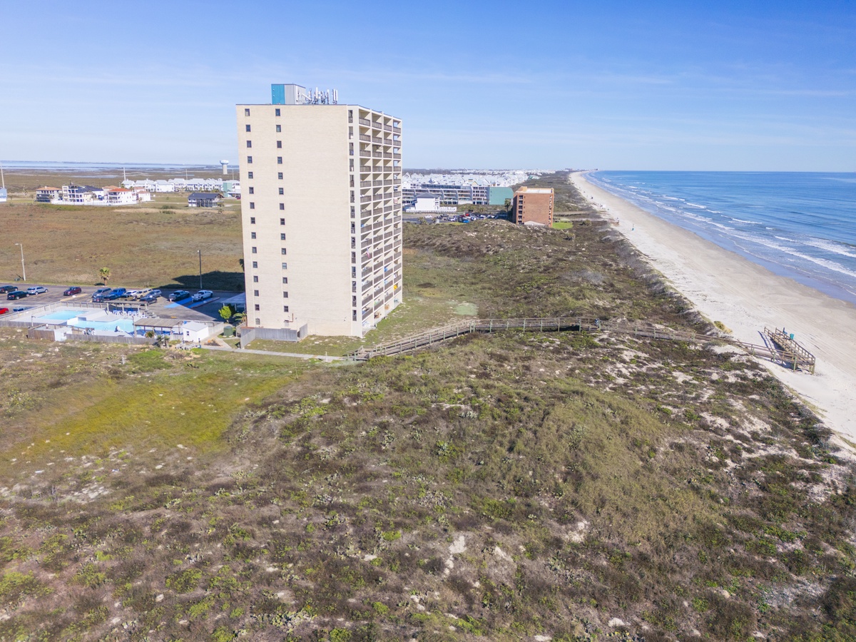 Beachfront property situated steps from pristine sandy shores with convenient beach access and stunning coastal surroundings.